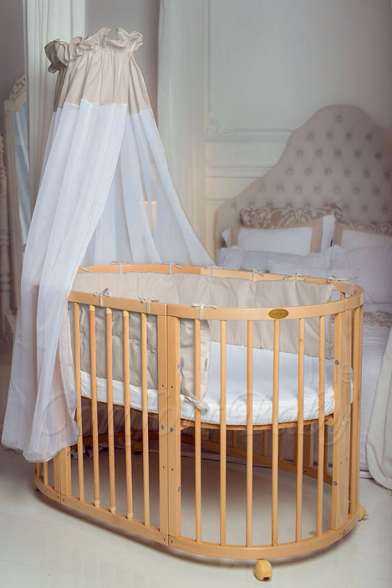 КРОВАТКА- ТРАНСФОРМЕР "COMFORT BABY" .Цена: 25 000 руб.  ХАРАКТЕРИСТИКИ:  возраст детей: 0-5 лет  габариты модели (Д х Ш х В): 1) колыбельки: 78*76*81 см  2) овальной кроватки: 128*76*81 cм  матрас приобретается отдельно.  максимальная нагрузка: 120 кг  Материал: изготавливается только из настоящего массива бука высшего сорта.  сборка: кровать в разобранном виде, простота сборки, инструкция по сборке на русском языке  продукция сертифицирована  производство: Россия  гарантия: 2 года   Дополнительные характеристики: 4 положения по высоте (расстояние положения дна от пола без колес: 1см, 12см, 37см, 57см; расстояние между отверстиями снизу-наверх: 12см, 15см, 20см.); 3 прутика - съемные.  КОНМПЛЕКТАЦИЯ:  1-я ступень - круглая кроватка  2-я ступень - овальная кроватка  3-я ступень - диванчик  4-я ступень - манеж  5-я и 6-я ступени - 2 кресла и столик  7-я ступень - пеленальный столик  ДОПОЛНИТЕЛЬНЫЕ ОПЦИИ:  Комплект постельный "Classic" +6950 руб.  Комплект постельный "Colorit" + 11990 руб.  Фирменный держатель для балдахина +790 руб.  Комплект цельных матрасов " Холкон"/ "Кокос" (круглый+овальный) +8490 руб  Маятник "ComfortBaby Pendulum" 2 в 1+6990 руб.