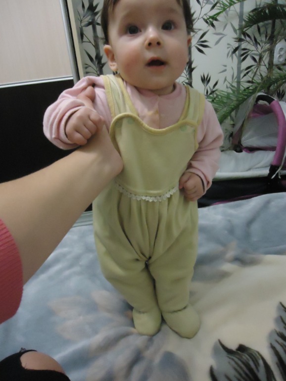 Кира держится за одну руку и стоит крепко сама!!!