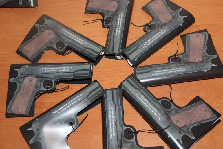 Приглашение пистолеи другие аксессуары для гангстерской вечеринки.